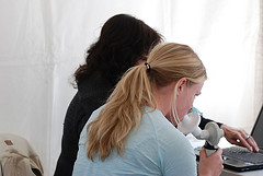 Lady using the white peak flow meter